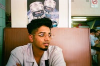 a man sitting at a table in a restaurant